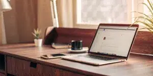 Entrepreneur writing Instagram bio on laptop.