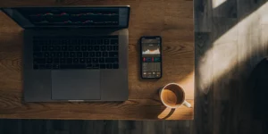 Instagram ad costs displayed on laptop and smartphone.
