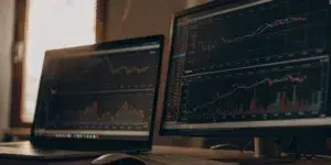 Google Ads automation dashboard on dual monitors.