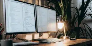JavaScript SEO audit code on dual monitors.