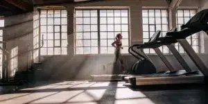 Gym member runs on treadmill. Fitness content creation for gyms and studios.