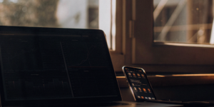 Laptop with analytics and a smartphone used to plan a winning social media SEO strategy.