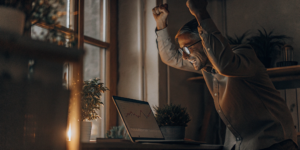 A marketer celebrates marketing ROI growth from a successful small creator partnership.