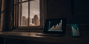 Laptop and smartphone with graphs showing how a data connection impacts revenue growth.