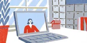 Marketing strategist reviewing an ecommerce online store performance in a bright modern office with stacked product boxes