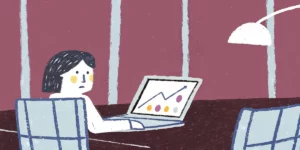 Marketing professional analyzing website analytics on a laptop in a modern office